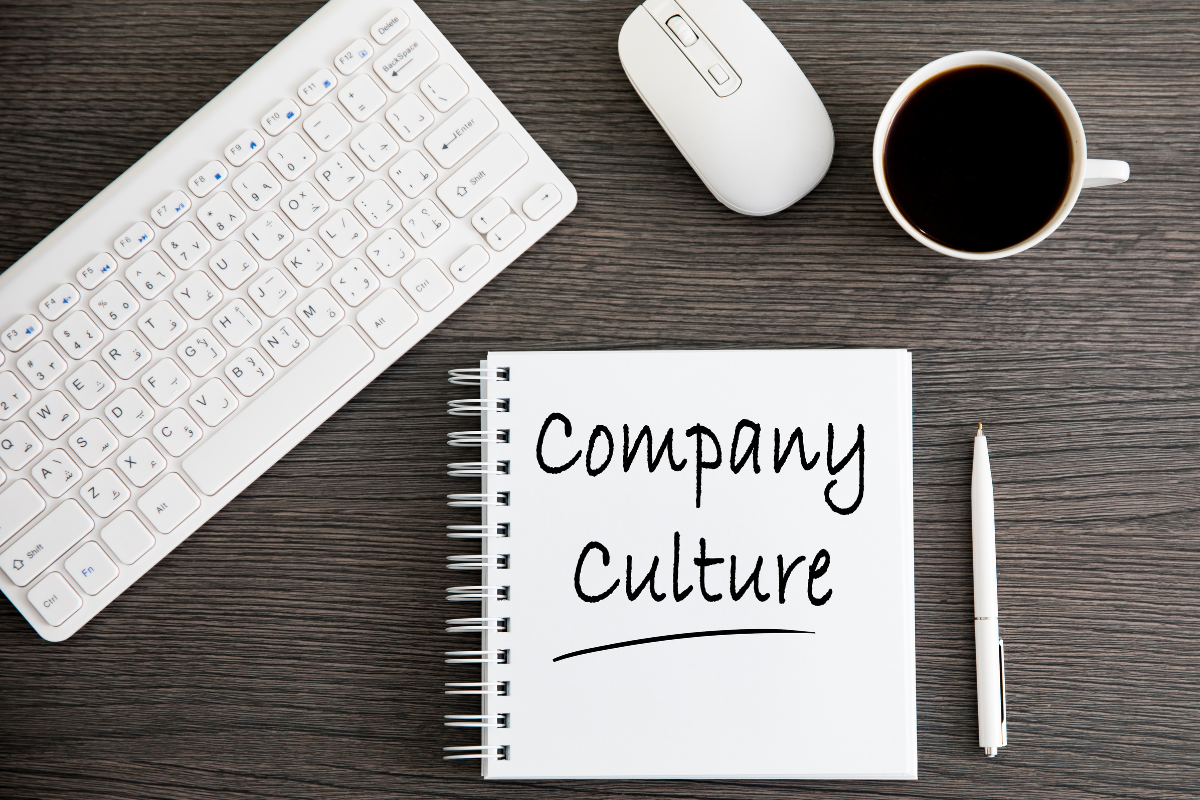An image featuring a notebook with the words “company culture” written on its pages.